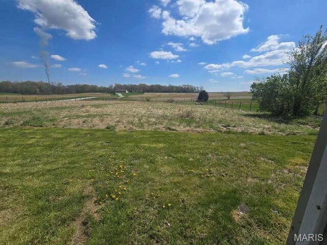 view of yard with a rural view