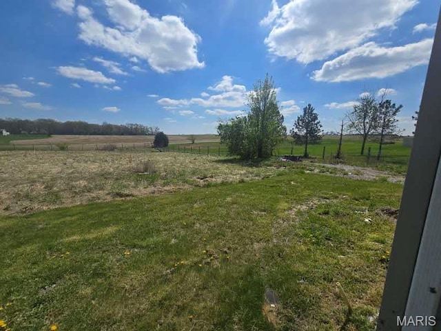 view of grassy yard with a view of countryside