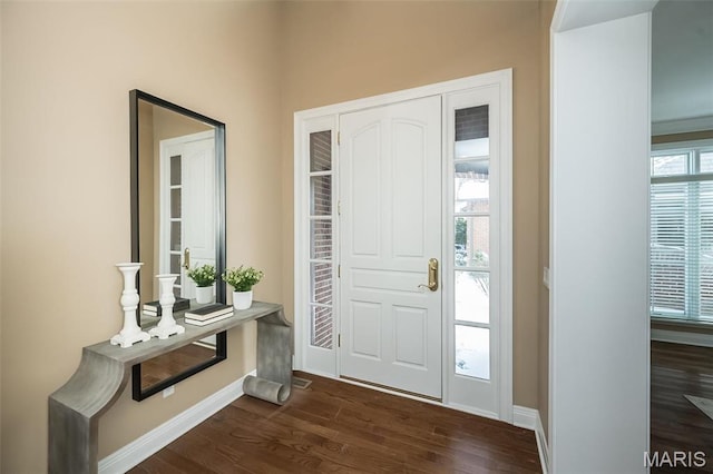 entrance foyer featuring dark wood-type flooring and baseboards