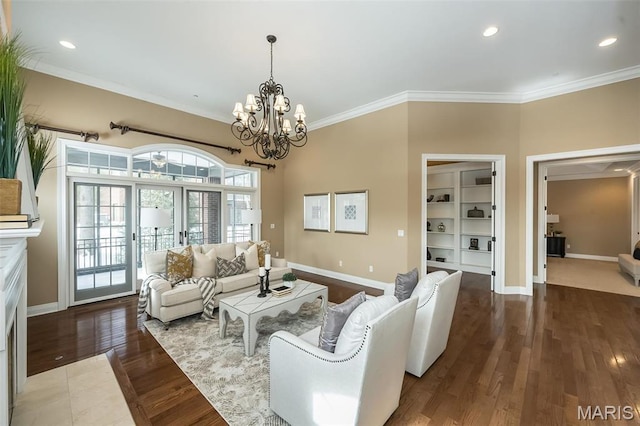 living area with a chandelier, crown molding, baseboards, recessed lighting, and wood finished floors