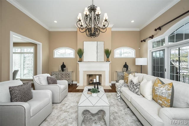 living area with a chandelier, wood finished floors, recessed lighting, crown molding, and a fireplace with flush hearth