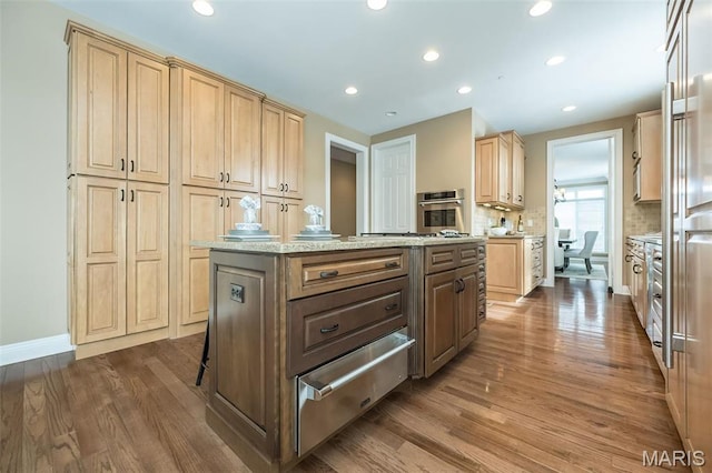 kitchen featuring a warming drawer, stainless steel oven, light brown cabinets, dark wood-style floors, and recessed lighting