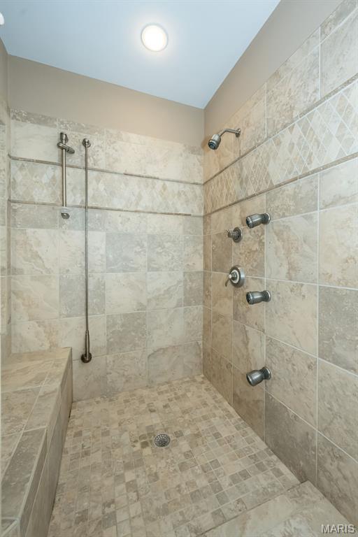 full bathroom with tiled shower