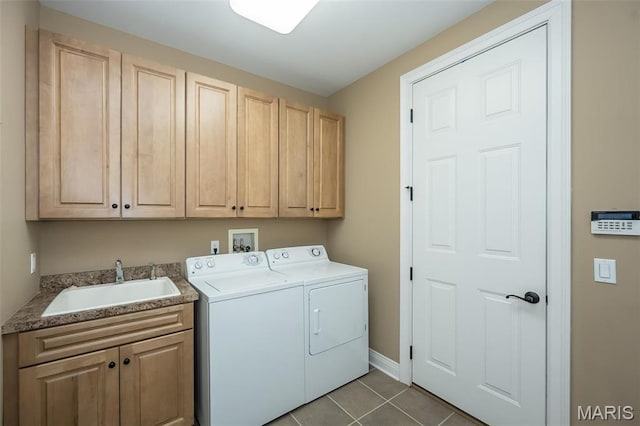 laundry area with separate washer and dryer, cabinet space, dark tile patterned floors, and baseboards