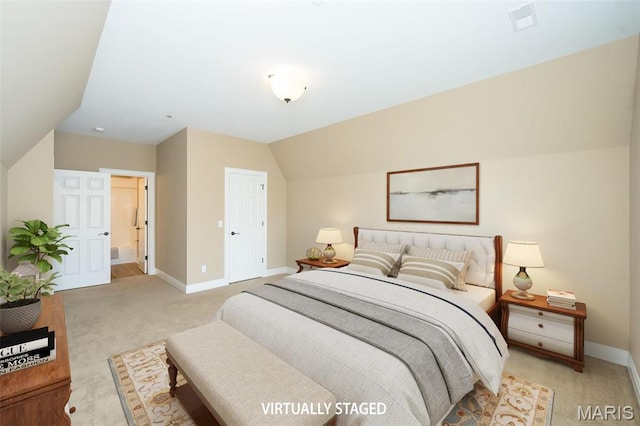 bedroom with light colored carpet, baseboards, and vaulted ceiling