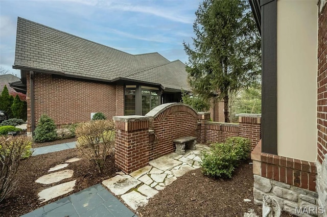 view of side of property with brick siding