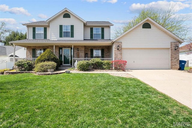 traditional home with an attached garage, driveway, brick siding, a front yard, and covered porch