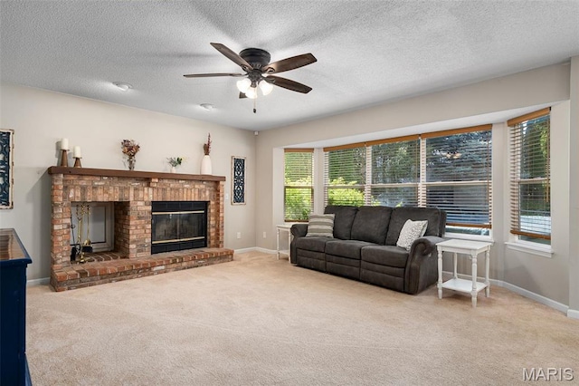 carpeted living area with a ceiling fan, a fireplace, baseboards, and a textured ceiling