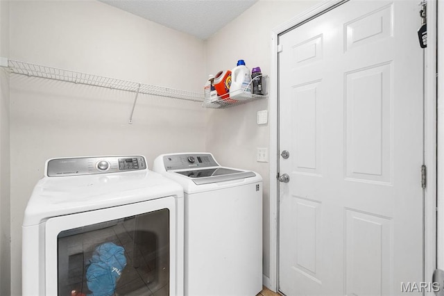 clothes washing area with independent washer and dryer