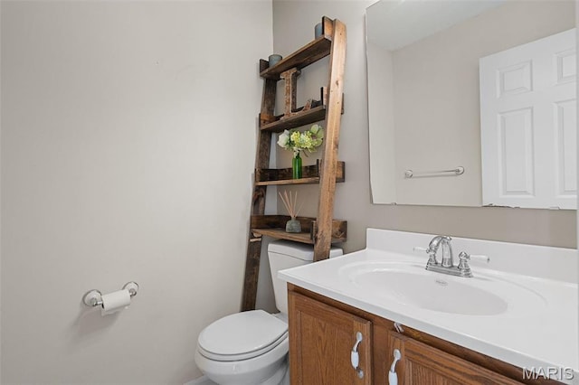 bathroom featuring toilet and vanity
