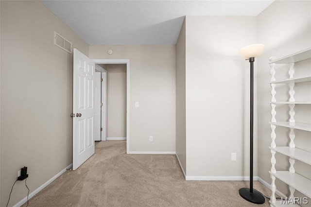 unfurnished bedroom with carpet floors, baseboards, and a closet