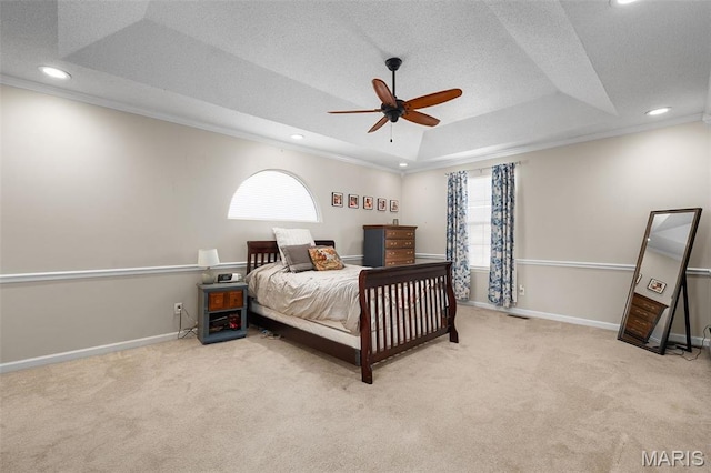 bedroom featuring a raised ceiling, carpet, crown molding, baseboards, and recessed lighting