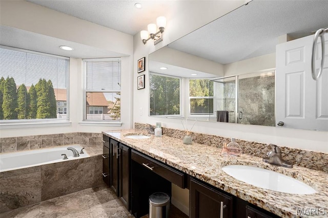 bathroom featuring a shower stall, a garden tub, and double vanity