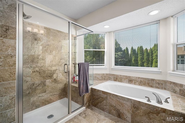full bath featuring a garden tub and a stall shower
