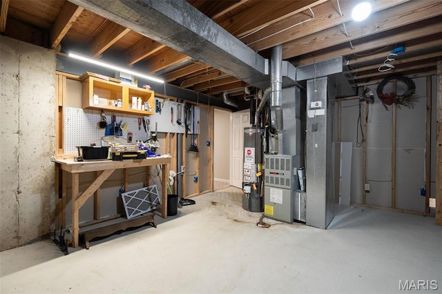 unfinished below grade area featuring a workshop area and gas water heater