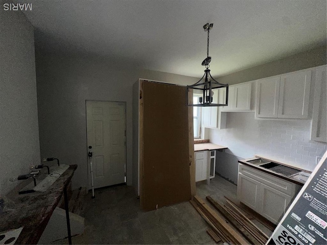 4439 Oakland Ave, Saint Louis, MO 63110 - kitchen featuring a chandelier, white cabinets, tasteful backsplash, and decorative light fixtures