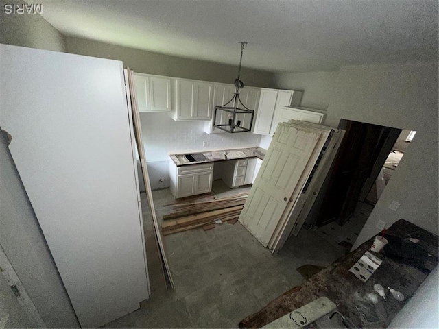 4439 Oakland Ave, Saint Louis, MO 63110 - kitchen featuring white cabinetry, freestanding refrigerator, and decorative light fixtures