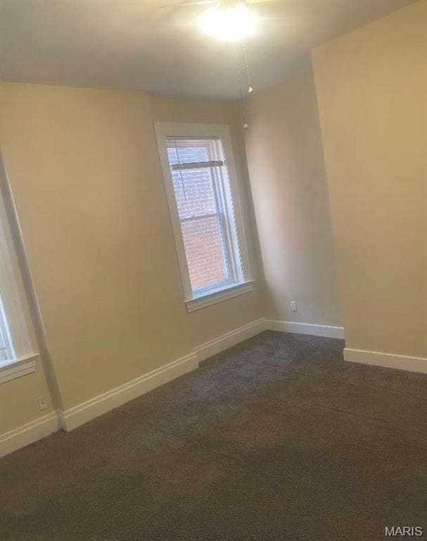 1208 N Euclid Ave, Saint Louis, MO 63113 - unfurnished room with baseboards and dark colored carpet