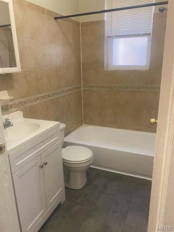 1208 N Euclid Ave, Saint Louis, MO 63113 - bathroom with tile walls, tub / shower combination, toilet, vanity, and tile patterned floors