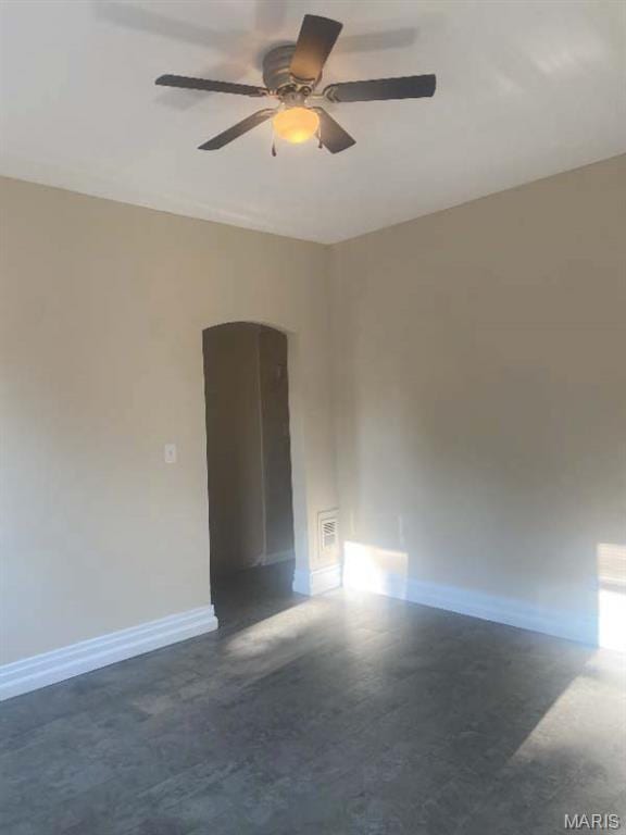 1208 N Euclid Ave, Saint Louis, MO 63113 - empty room featuring a ceiling fan, arched walkways, and baseboards