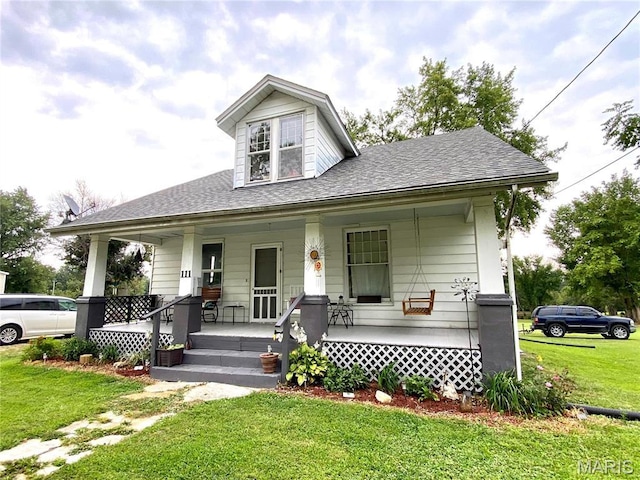 111 SE St, Wellsville, MO 63384 - bungalow-style house featuring a porch, a front lawn, and roof with shingles