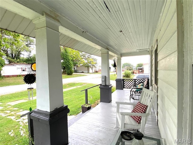 111 SE St, Wellsville, MO 63384 - wooden deck featuring covered porch and a yard