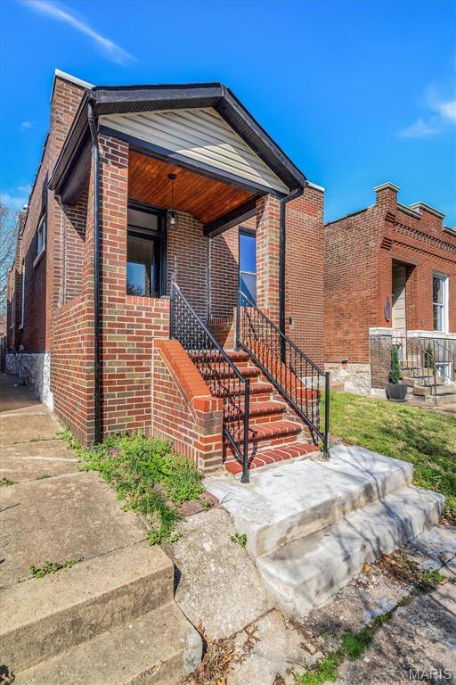 4021 Winnebago St, Saint Louis, MO 63116 - view of front of house with stairs and brick siding