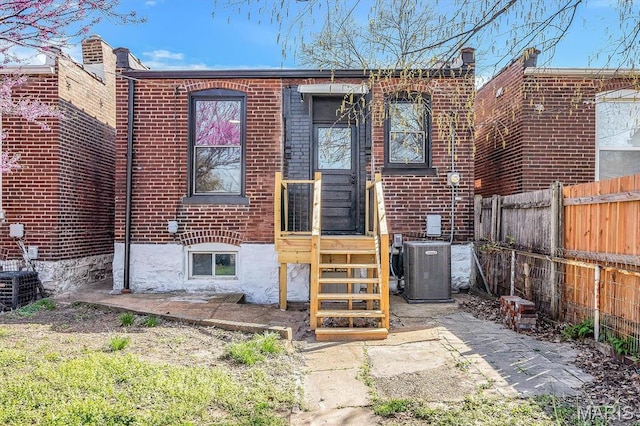 4021 Winnebago St, Saint Louis, MO 63116 - back of house featuring fence, cooling unit, and brick siding