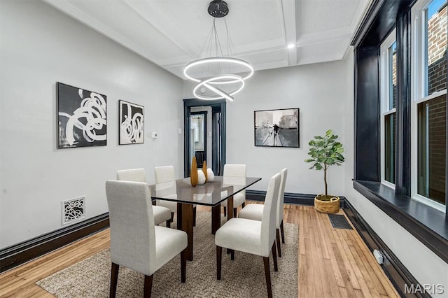4021 Winnebago St, Saint Louis, MO 63116 - dining area featuring a chandelier, coffered ceiling, light wood-style floors, beam ceiling, and baseboards