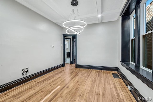 4021 Winnebago St, Saint Louis, MO 63116 - unfurnished room featuring a chandelier, coffered ceiling, light wood-style flooring, beam ceiling, and baseboards