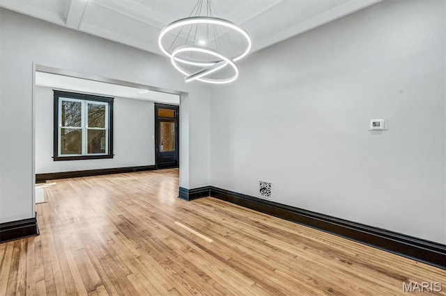 4021 Winnebago St, Saint Louis, MO 63116 - unfurnished dining area with a chandelier, wood-type flooring, and baseboards