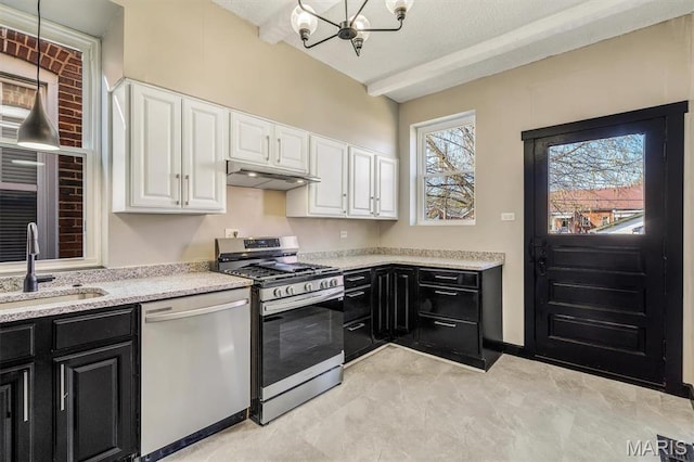 4021 Winnebago St, Saint Louis, MO 63116 - kitchen with appliances with stainless steel finishes, dark cabinetry, a sink, and a chandelier