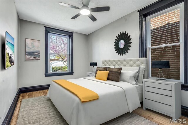 4021 Winnebago St, Saint Louis, MO 63116 - bedroom with light wood-type flooring, baseboards, and a ceiling fan