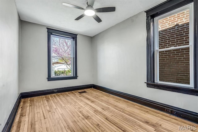 4021 Winnebago St, Saint Louis, MO 63116 - empty room featuring a ceiling fan, wood-type flooring, and baseboards