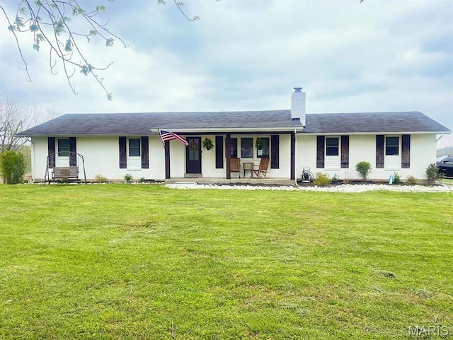 ranch-style house featuring a porch, a chimney, and a front lawn