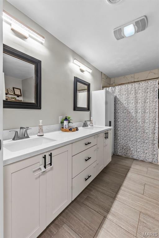 bathroom featuring double vanity and a shower with curtain