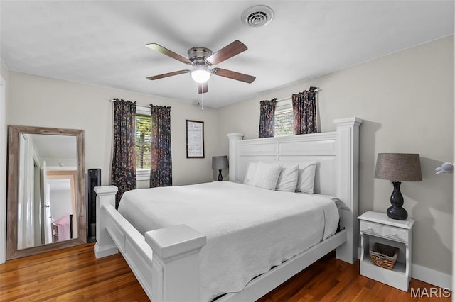 bedroom with wood finished floors, a ceiling fan, and baseboards