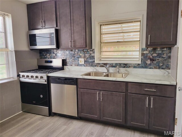 8303 Knollwood Dr, Saint Louis, MO 63121 - kitchen featuring stainless steel appliances, a sink, healthy amount of natural light, and light wood-type flooring