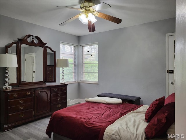 8303 Knollwood Dr, Saint Louis, MO 63121 - bedroom featuring light wood finished floors, a ceiling fan, and baseboards