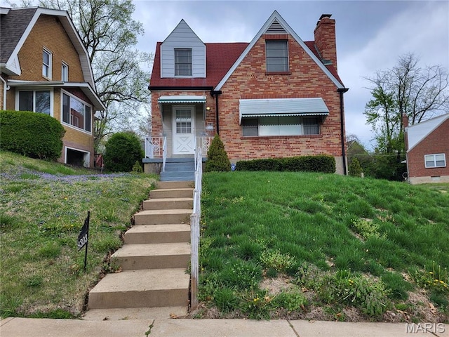 8303 Knollwood Dr, Saint Louis, MO 63121 - view of front of home featuring brick siding and a chimney