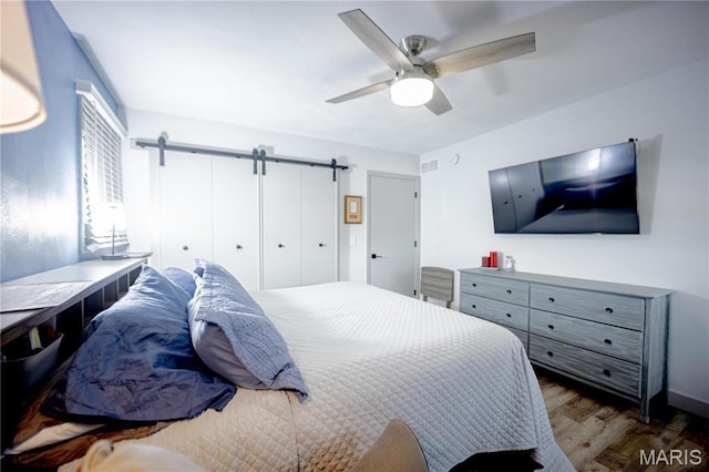 5826 Grandview Ter, Waterloo, IL 62298 - bedroom featuring wood finished floors, a barn door, and a ceiling fan