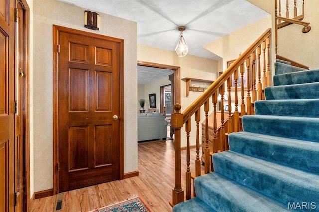 411 S High St, Belleville, IL 62220 - foyer entrance featuring stairway, light wood-style flooring, and baseboards
