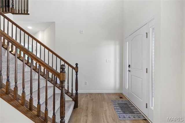 809 Colony Ridge Ct, Foristell, MO 63348 - foyer entrance featuring wood finished floors, baseboards, stairway, and a towering ceiling
