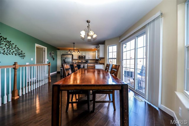2605 Buenger Blvd, Granite City, IL 62040 - dining space featuring a chandelier, dark wood finished floors, and baseboards