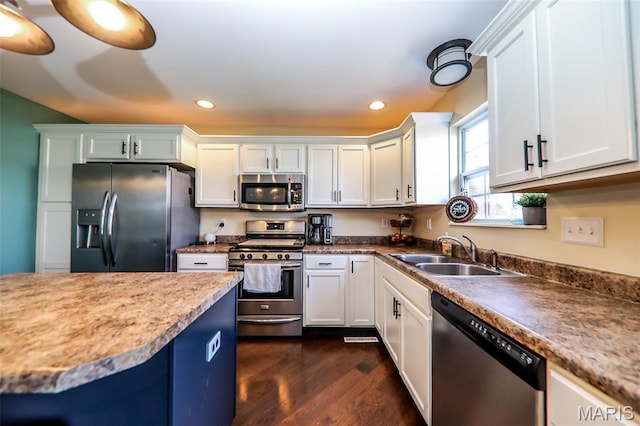 2605 Buenger Blvd, Granite City, IL 62040 - kitchen with stainless steel appliances, a sink, dark wood finished floors, recessed lighting, and white cabinets