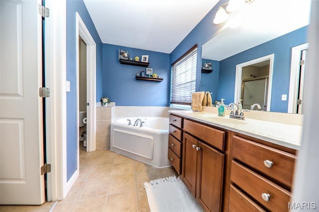 2605 Buenger Blvd, Granite City, IL 62040 - bathroom with toilet, tile patterned floors, vanity, a bath, and a stall shower