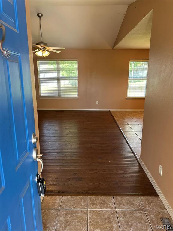 142 Oregon Ln, Kimberling City, MO 65686 - entryway featuring vaulted ceiling, tile patterned flooring, ceiling fan, and baseboards
