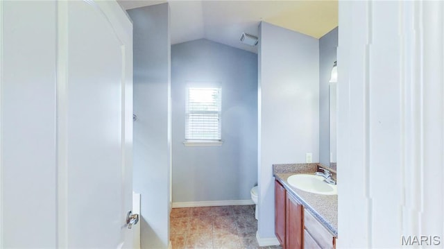 142 Oregon Ln, Kimberling City, MO 65686 - bathroom with vanity, toilet, lofted ceiling, tile patterned flooring, and baseboards