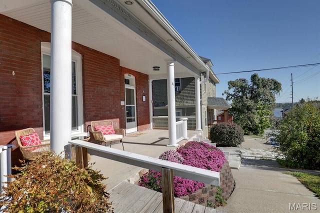 view of home's exterior with covered porch and brick siding