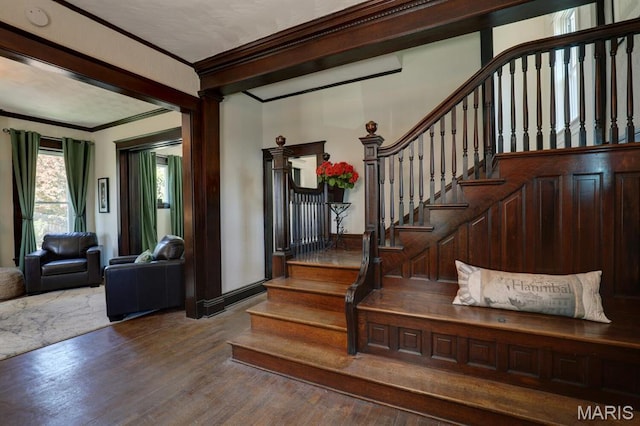entryway featuring crown molding, wood finished floors, and stairway